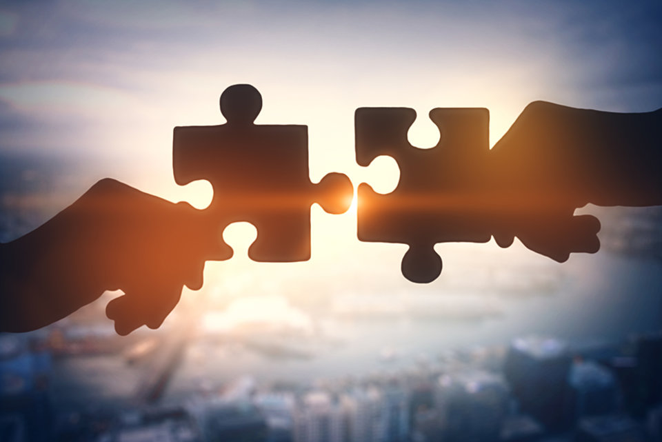 hands putting puzzle pieces together hands putting puzzle pieces together